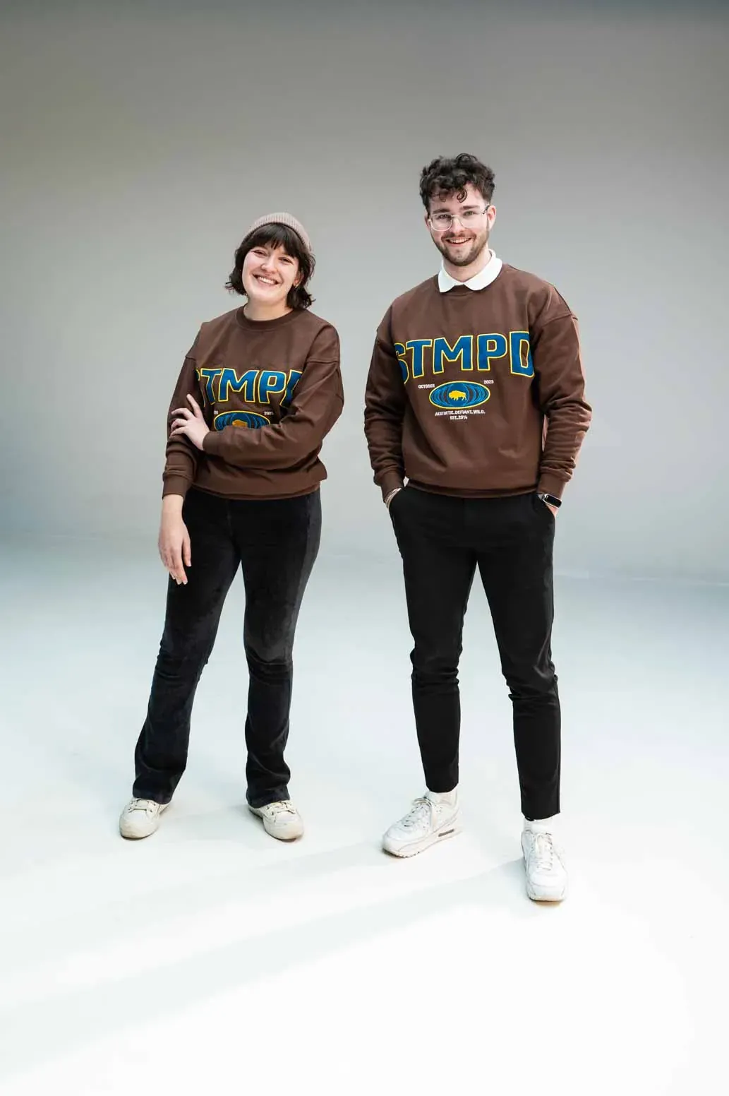 Two people wearing the brown Freshmen '25 Crewneck